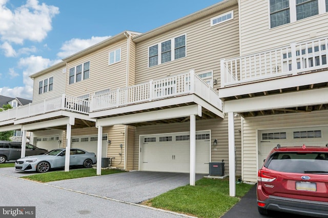 221 Patriots Path, Malvern, PA 19355 - rear view of property featuring an attached garage, driveway, and a balcony