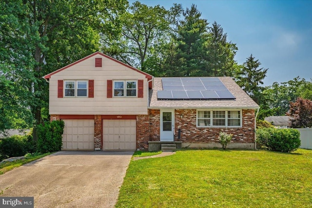 103 Lincoln Ave S, Cherry Hill, NJ 08002 - tri-level home with an attached garage, driveway, solar panels, brick siding, and roof with shingles