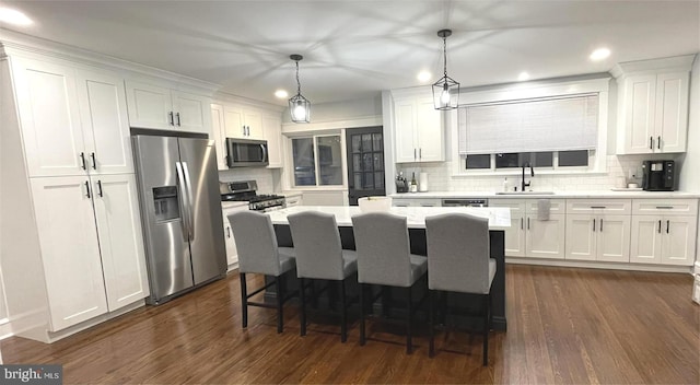 24 Sterner Ave, Broomall, PA 19008 - kitchen with stainless steel appliances, white cabinetry, tasteful backsplash, dark wood finished floors, and recessed lighting