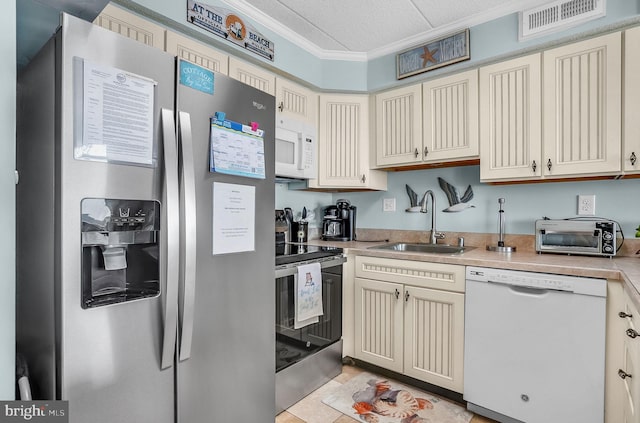 427 14th St Unit 10203, Ocean City, MD 21842 - kitchen with stainless steel appliances, crown molding, cream cabinets, light countertops, and a textured ceiling