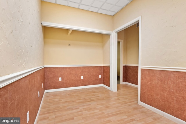 128 E Main St, Palmyra, PA 17078 - empty room with wood finished floors and a wainscoted wall