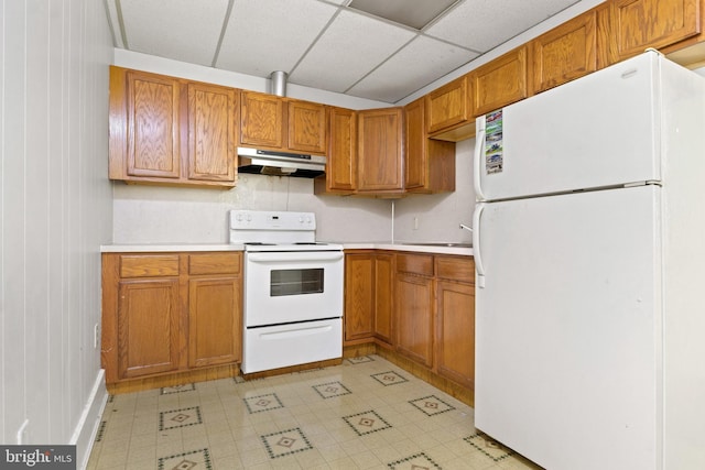 128 E Main St, Palmyra, PA 17078 - kitchen with white appliances, under cabinet range hood, light countertops, light floors, and a drop ceiling