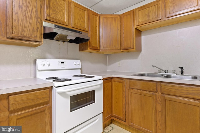 128 E Main St, Palmyra, PA 17078 - kitchen featuring white electric range, under cabinet range hood, light countertops, and brown cabinetry