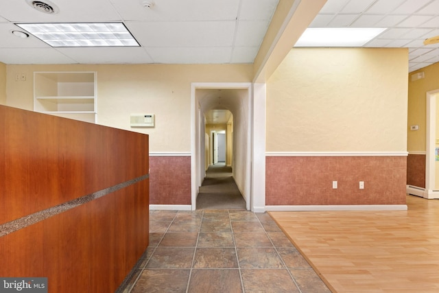 128 E Main St, Palmyra, PA 17078 - corridor featuring a drop ceiling, arched walkways, a wainscoted wall, and a baseboard heating unit