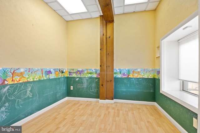 128 E Main St, Palmyra, PA 17078 - spare room with wood finished floors, a paneled ceiling, and wallpapered walls