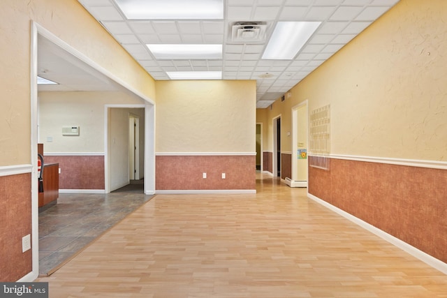 128 E Main St, Palmyra, PA 17078 - spare room featuring wood finished floors, wainscoting, and a drop ceiling
