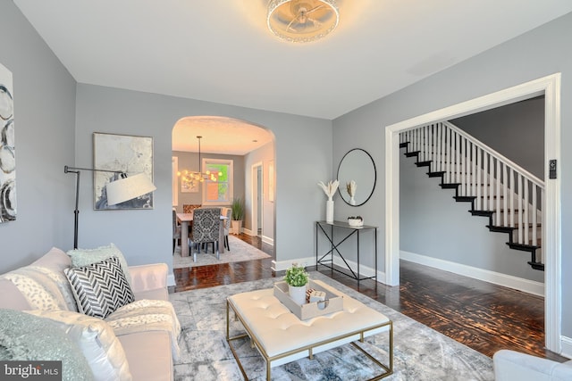 4316 Shamrock Ave, Baltimore, MD 21206 - living room with arched walkways, wood finished floors, a chandelier, and stairway