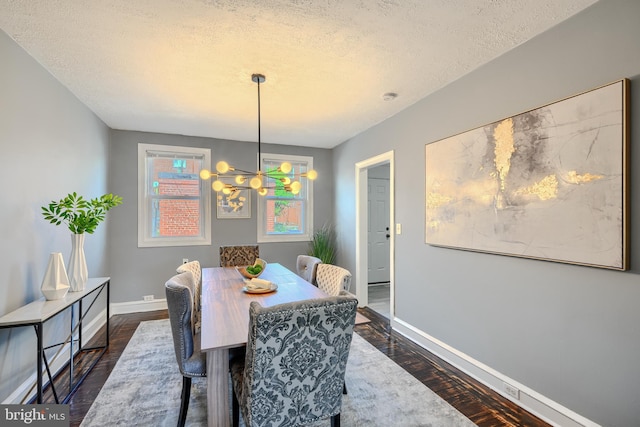 4316 Shamrock Ave, Baltimore, MD 21206 - dining room with dark wood-type flooring, a textured ceiling, and a chandelier