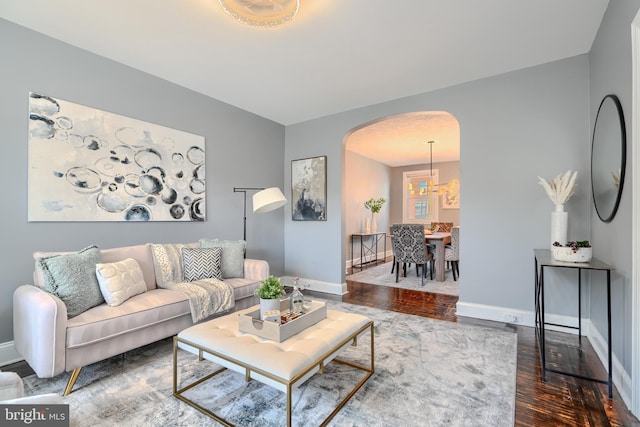 4316 Shamrock Ave, Baltimore, MD 21206 - living area with arched walkways and dark wood-style floors