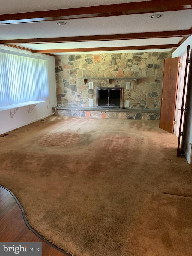 70 Hargrave Ln, Media, PA 19063 - unfurnished living room featuring beam ceiling, a fireplace, and wood finished floors