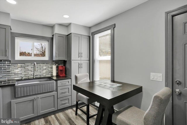 553 Wunder St Fl 1St, Reading, PA 19602 - kitchen with gray cabinets, dark countertops, healthy amount of natural light, decorative backsplash, and recessed lighting