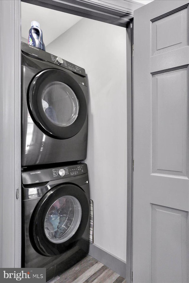 553 Wunder St Fl 1St, Reading, PA 19602 - washroom with stacked washer / dryer and wood finished floors