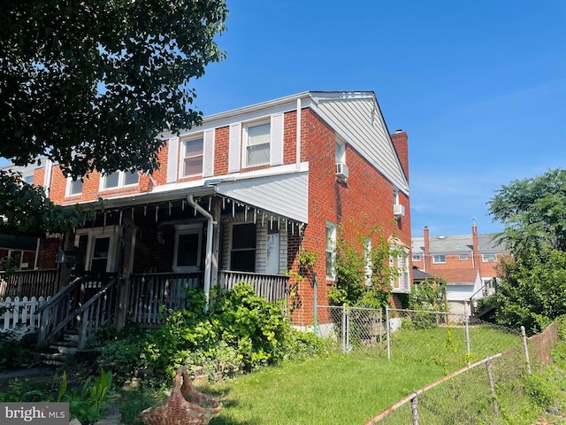1902 Kelmore Rd, Baltimore, MD 21222 - rear view of property featuring brick siding, covered porch, and a chimney
