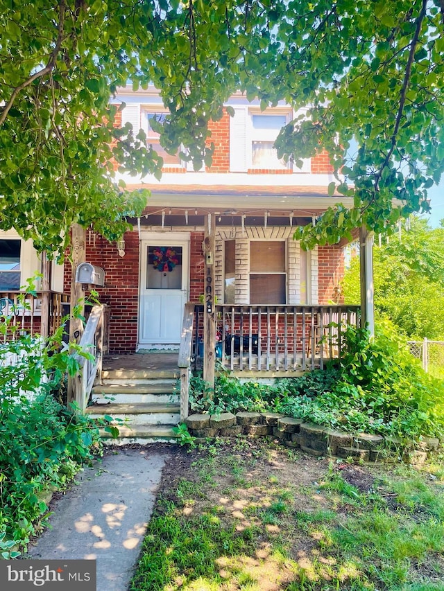 1902 Kelmore Rd, Baltimore, MD 21222 - view of front of house with brick siding and a porch