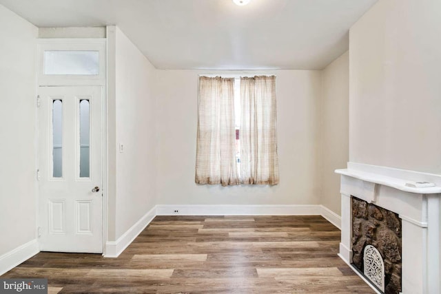 3339 N 21st St, Philadelphia, PA 19140 - unfurnished living room featuring wood finished floors and a fireplace