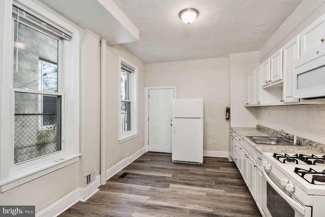 3339 N 21st St, Philadelphia, PA 19140 - kitchen with white appliances, white cabinets, light countertops, and dark wood-style flooring