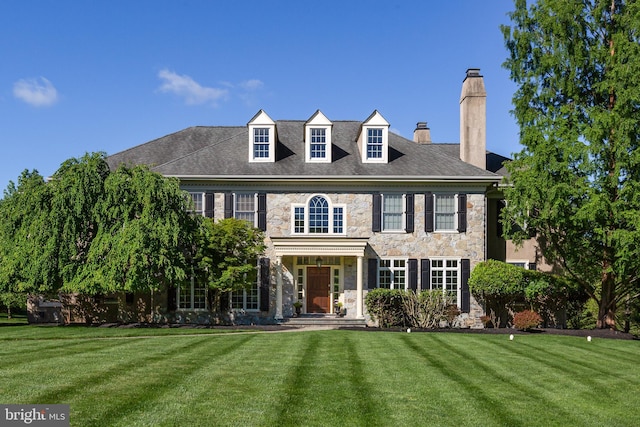 211 Twinings Ln, Wayne, PA 19087 - colonial house with stone siding, a chimney, and a front lawn