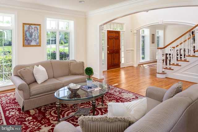 211 Twinings Ln, Wayne, PA 19087 - living room with arched walkways, wood finished floors, ornamental molding, and stairway