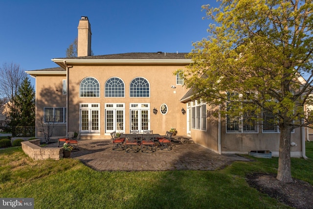 211 Twinings Ln, Wayne, PA 19087 - back of property featuring french doors, a patio, a yard, a chimney, and stucco siding
