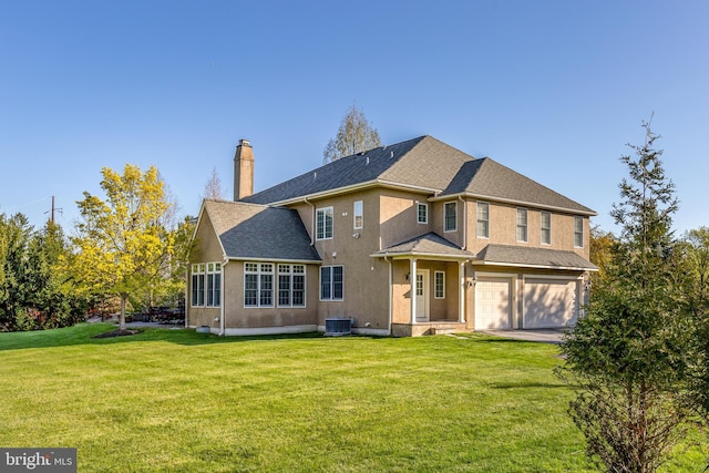 211 Twinings Ln, Wayne, PA 19087 - back of property featuring a chimney, a garage, a yard, and driveway
