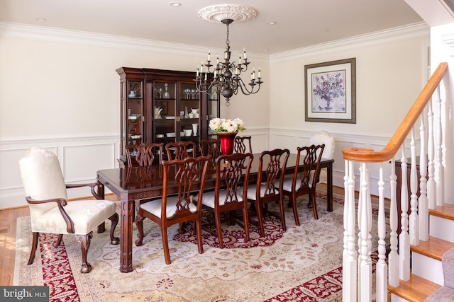 211 Twinings Ln, Wayne, PA 19087 - dining area with wood finished floors, a chandelier, ornamental molding, arched walkways, and wainscoting