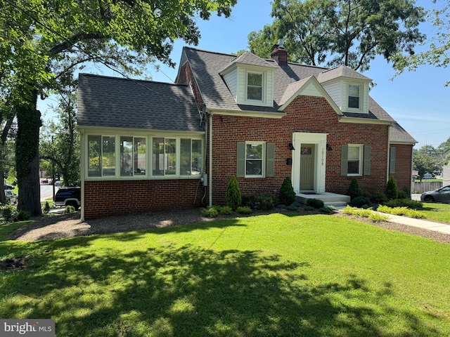 10109 Lorain Ave, Silver Spring, MD 20901 - view of front of home featuring a front lawn, brick siding, a chimney, and a shingled roof