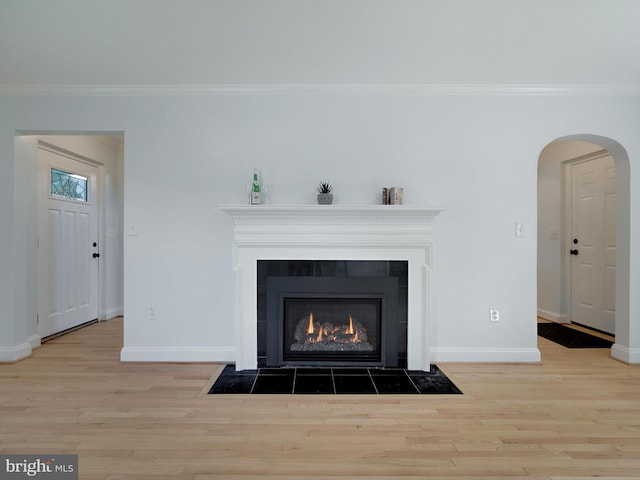 10109 Lorain Ave, Silver Spring, MD 20901 - detailed view of ornamental molding, wood finished floors, a fireplace with flush hearth, and arched walkways