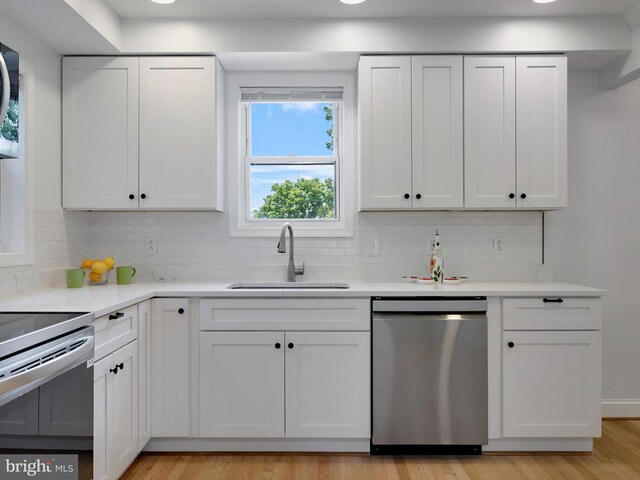 10109 Lorain Ave, Silver Spring, MD 20901 - kitchen featuring appliances with stainless steel finishes, backsplash, and white cabinetry