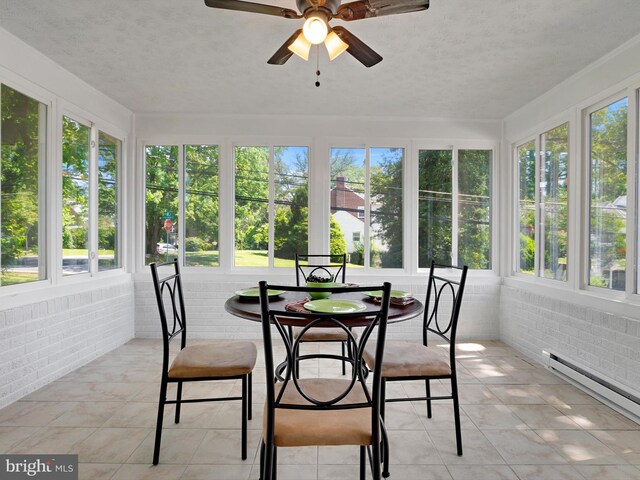 10109 Lorain Ave, Silver Spring, MD 20901 - sunroom / solarium featuring brick wall, healthy amount of natural light, a baseboard heating unit, and tile patterned flooring