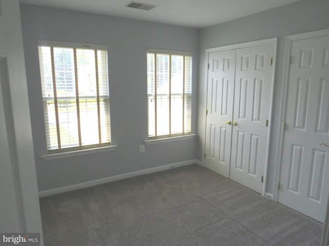 13937 Alderton Rd, Silver Spring, MD 20906 - unfurnished bedroom featuring carpet floors, multiple windows, and a closet