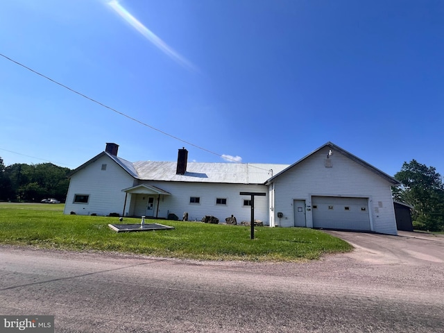 733 Saint Paul Rd, Meyersdale, PA 15552 - view of front facade featuring a chimney, a front yard, asphalt driveway, and a garage