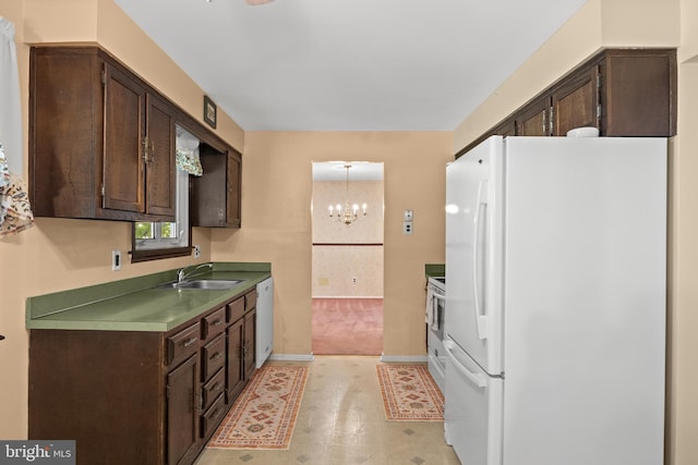 269 Burning Tree Rd, Delran, NJ 08075 - kitchen with white appliances, dark brown cabinetry, a chandelier, and light carpet