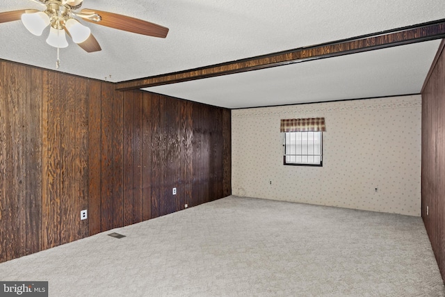 269 Burning Tree Rd, Delran, NJ 08075 - carpeted spare room featuring wooden walls, a ceiling fan, wallpapered walls, and a textured ceiling