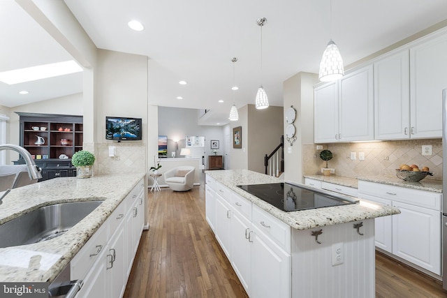 12801 Owlsley Way, Herndon, VA 20171 - kitchen with black electric cooktop, a kitchen island, tasteful backsplash, wood finished floors, and open floor plan