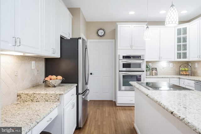 12801 Owlsley Way, Herndon, VA 20171 - kitchen with stainless steel appliances, tasteful backsplash, white cabinetry, light wood-style flooring, and recessed lighting