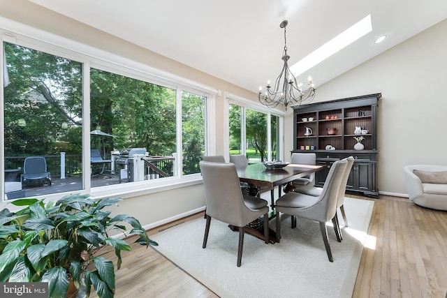 12801 Owlsley Way, Herndon, VA 20171 - dining space with a chandelier, lofted ceiling, light wood-type flooring, and a skylight