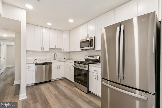 826 Quince Orchard Blvd Unit 101, Gaithersburg, MD 20878 - kitchen featuring stainless steel appliances, white cabinetry, tasteful backsplash, and recessed lighting