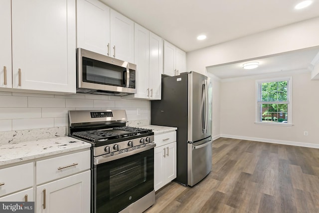 826 Quince Orchard Blvd Unit 101, Gaithersburg, MD 20878 - kitchen with stainless steel appliances, wood finished floors, tasteful backsplash, white cabinets, and light stone counters