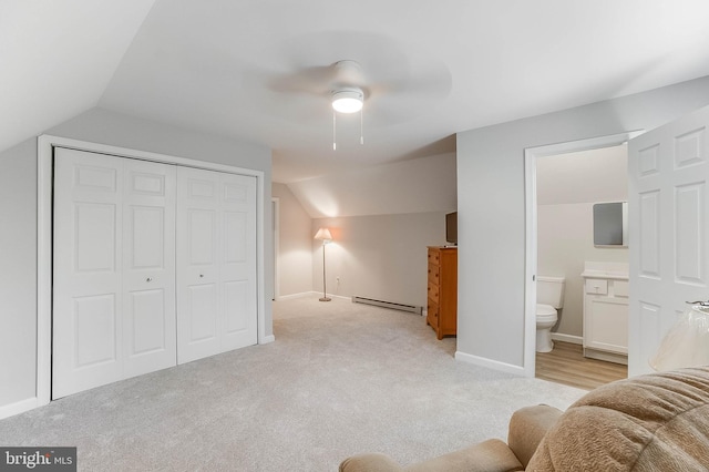 6508 Millcreek Rd, Laurel, DE 19956 - bedroom featuring a baseboard heating unit, lofted ceiling, a closet, light colored carpet, and ensuite bath