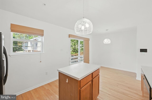 5311 Thomas Sim Lee Ter, Upper Marlboro, MD 20772 - kitchen with light wood finished floors, a chandelier, appliances with stainless steel finishes, light countertops, and hanging light fixtures