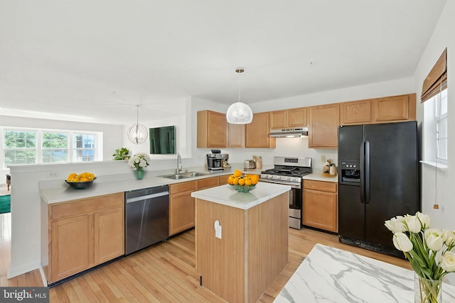 5311 Thomas Sim Lee Ter, Upper Marlboro, MD 20772 - kitchen with appliances with stainless steel finishes, under cabinet range hood, light wood-style floors, light countertops, and a center island