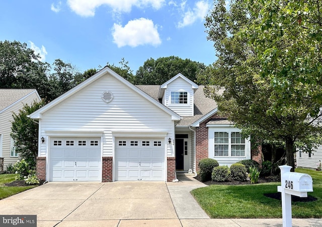246 Night Hawk Cir, West Deptford, NJ 08086 - traditional home with brick siding, driveway, an attached garage, and a shingled roof