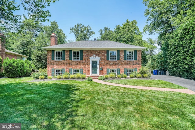 1930 Foxhall Rd, Mclean, VA 22101 - bi-level home featuring brick siding, a chimney, and a front lawn