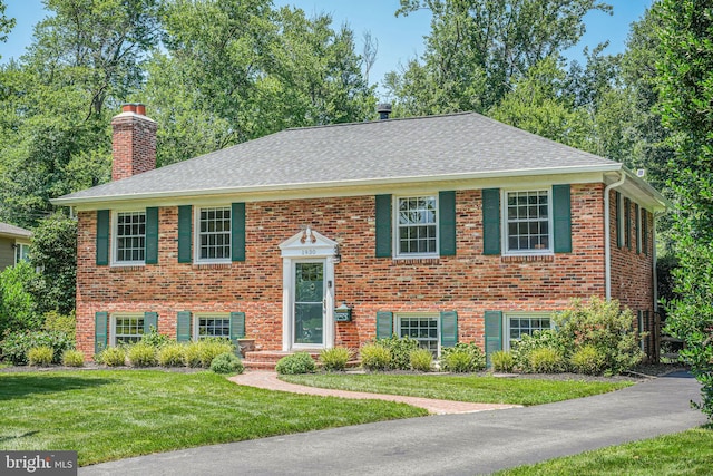 1930 Foxhall Rd, Mclean, VA 22101 - bi-level home with a chimney, a shingled roof, a front lawn, and brick siding