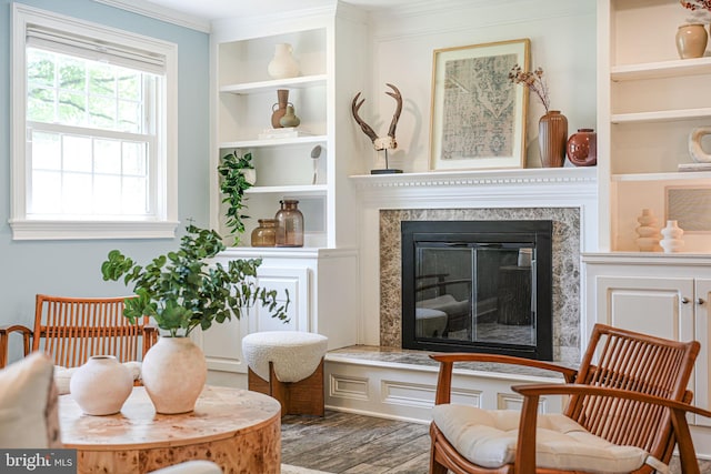 1930 Foxhall Rd, Mclean, VA 22101 - sitting room with wood finished floors, a high end fireplace, ornamental molding, and built in shelves