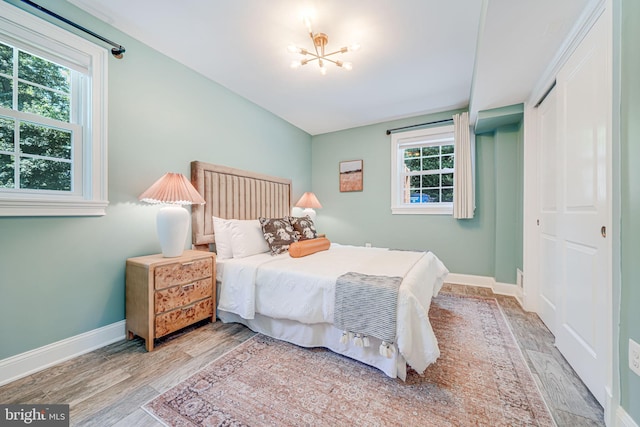 1930 Foxhall Rd, Mclean, VA 22101 - bedroom with wood finished floors, a chandelier, and a closet