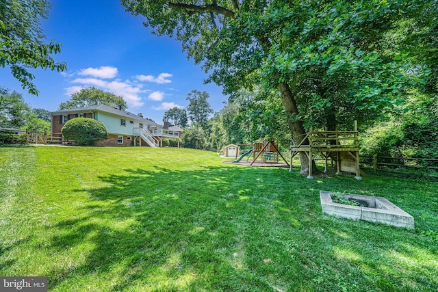 1930 Foxhall Rd, Mclean, VA 22101 - view of yard featuring a storage shed, stairs, a wooden deck, and a playground