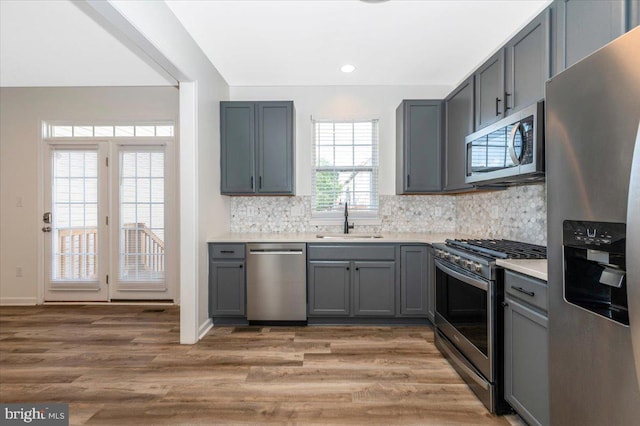 1806 Wheyfield Dr, Frederick, MD 21701 - kitchen with stainless steel appliances, gray cabinets, tasteful backsplash, light wood-type flooring, and recessed lighting