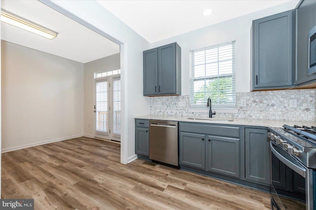 1806 Wheyfield Dr, Frederick, MD 21701 - kitchen with stainless steel appliances, tasteful backsplash, light wood finished floors, light countertops, and gray cabinetry