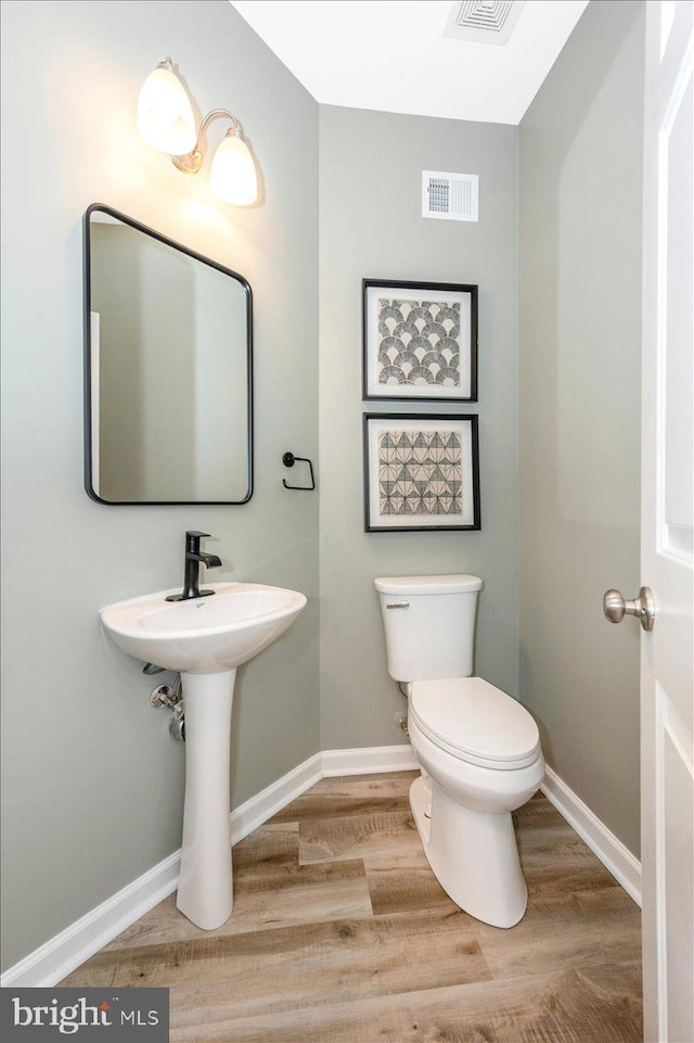 1806 Wheyfield Dr, Frederick, MD 21701 - half bath with wood finished floors and toilet